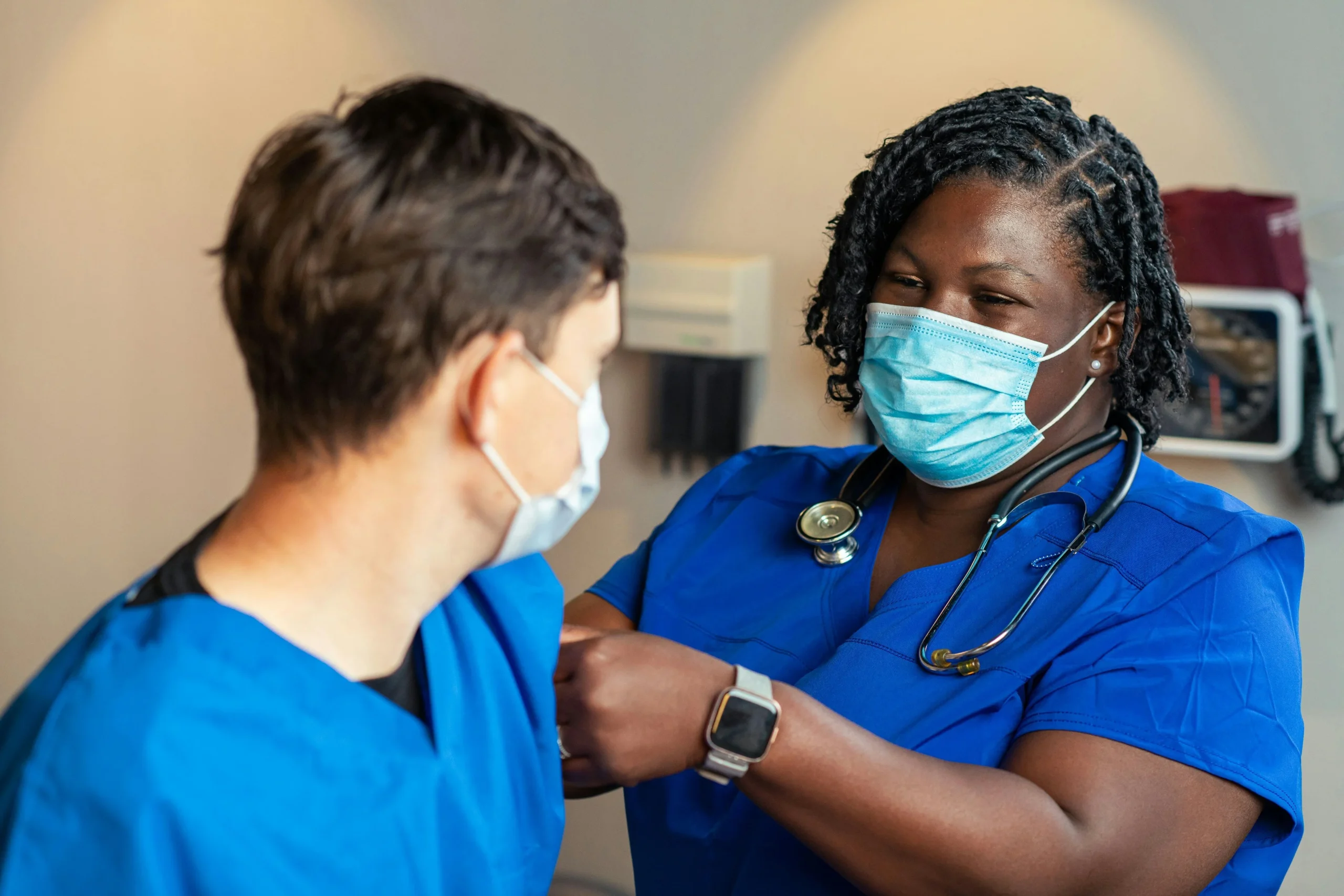 Medical staff checking blood pressure on patient