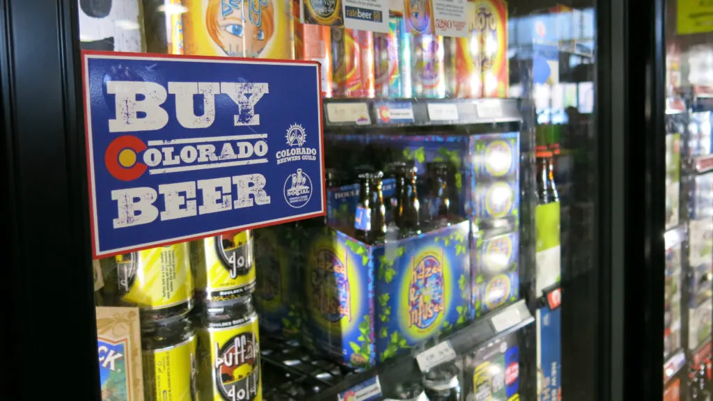 Hundreds of beers fill the coolers at Argonaut Wine & Liquor in Denver. Stores and breweries sold 115 million gallons of beer in Colorado last year, the most in at least three decades.